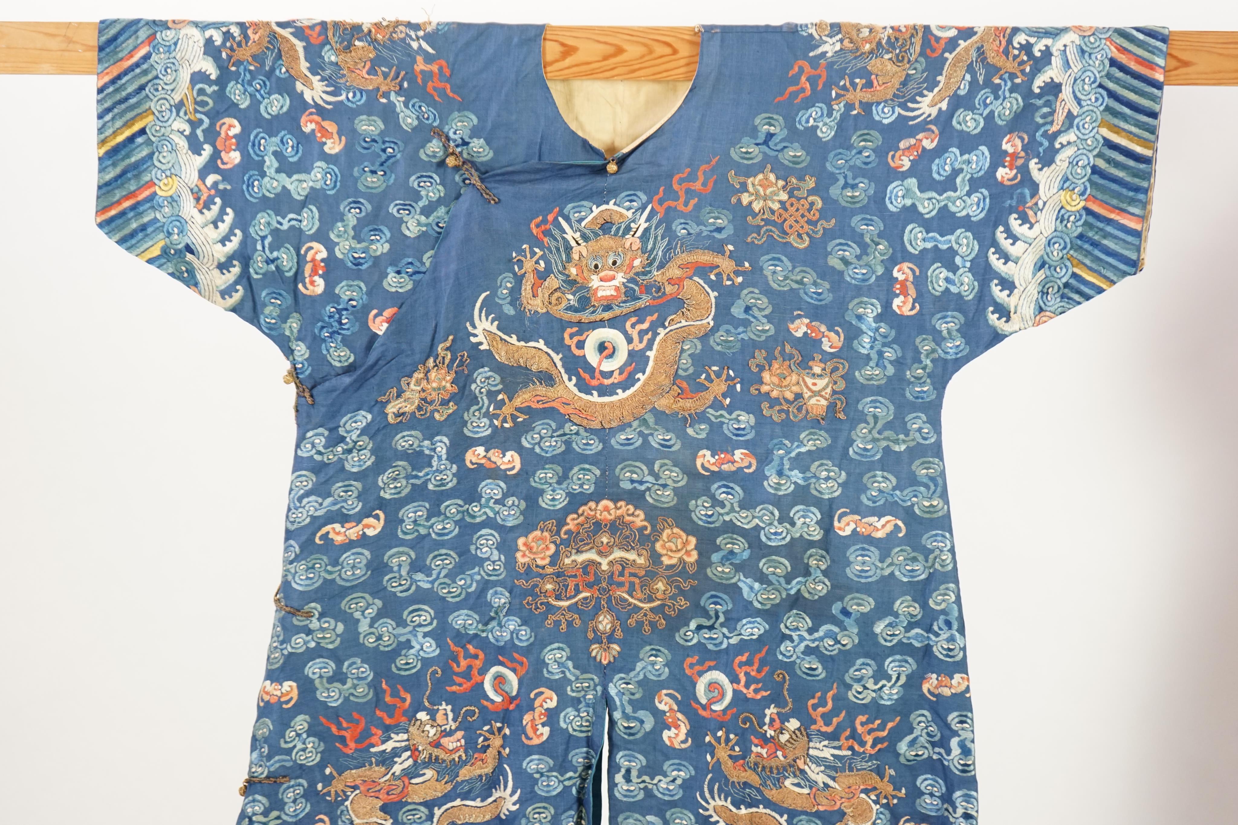 A Chinese blue silk ‘dragon’ robe, jifu, late 19th century and a mandarin hat